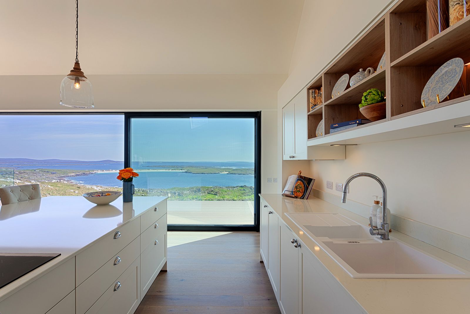 Close-up of a modern, minimalist sink and faucet fixture in a luxury bathroom or kitchen.