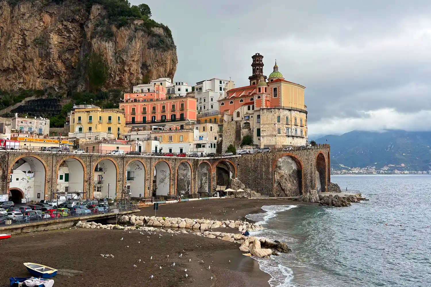 Coastal town with whitewashed buildings nestled on cliffs overlooking the shoreline of Atrani.