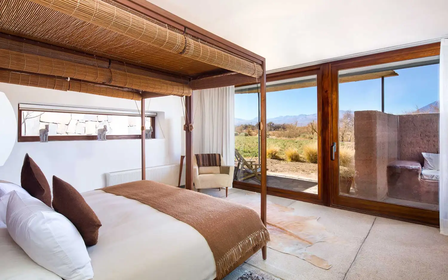 A minimalist and warm luxury guest room interior at Tierra Atacama.