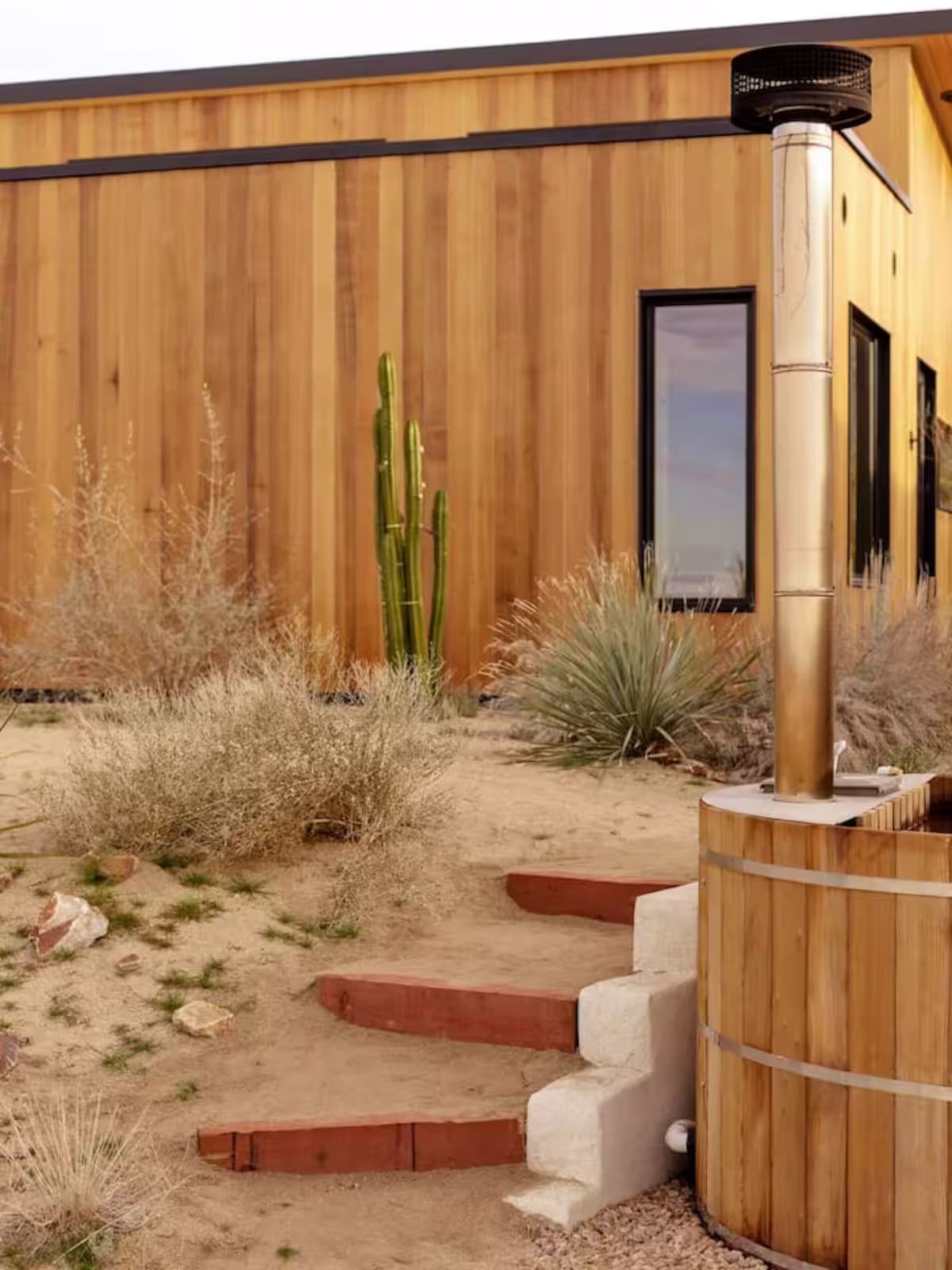 A luxurious backyard deck with wood accents connecting the interior to the desert outdoors.