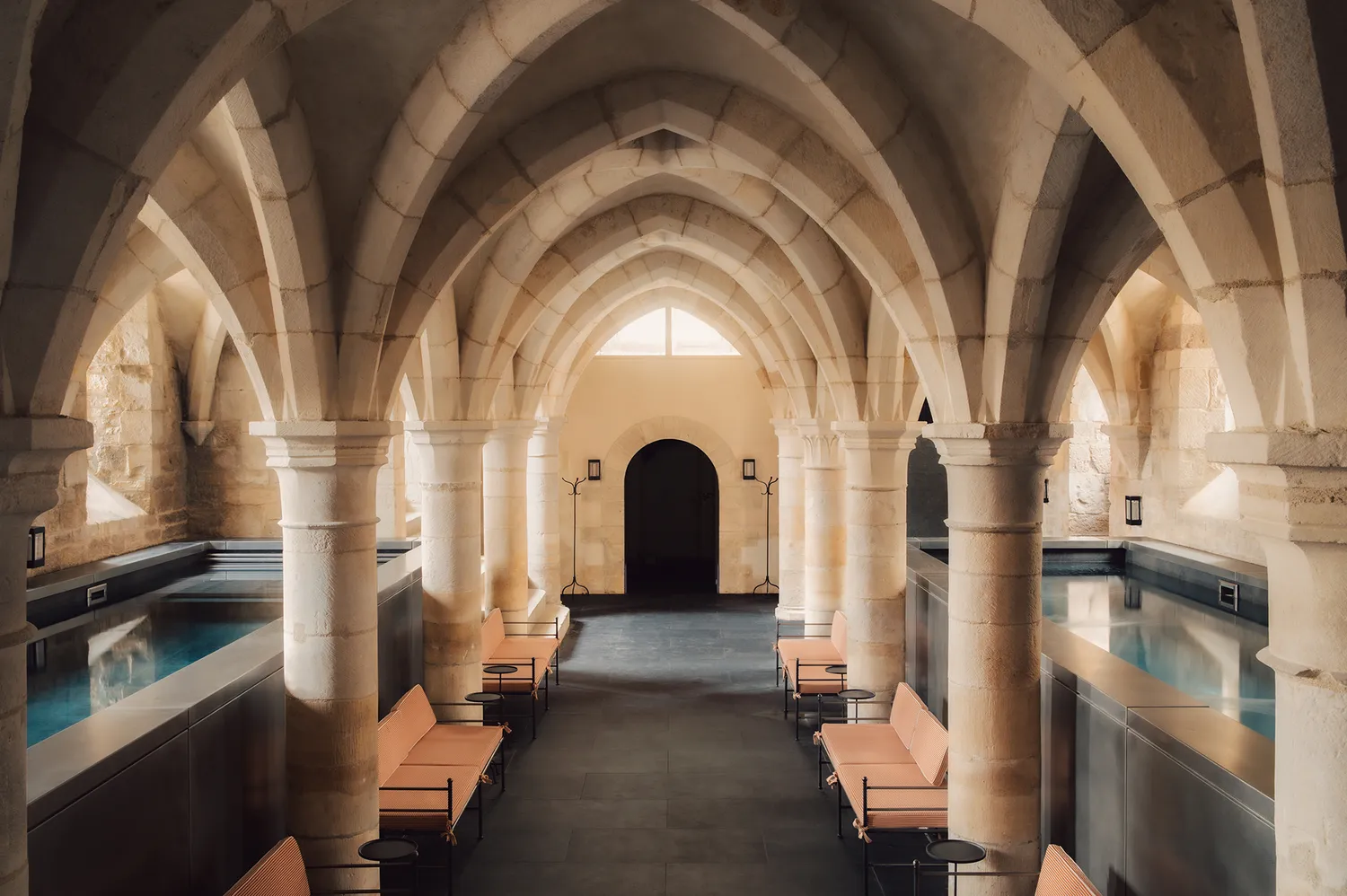 An underground spa with 14th-century vaulted stone ceilings and illuminated pools.