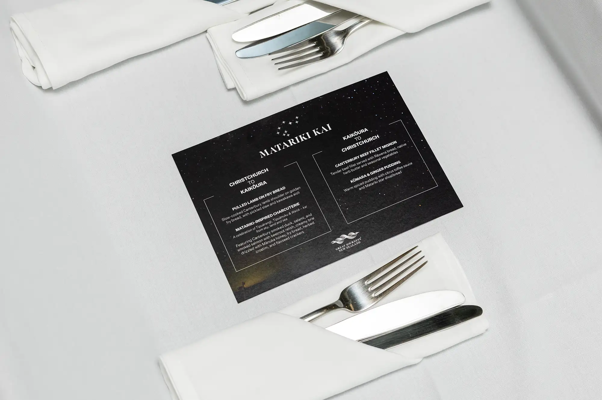 A white napkin with a menu card titled Matariki Kai on a table.
