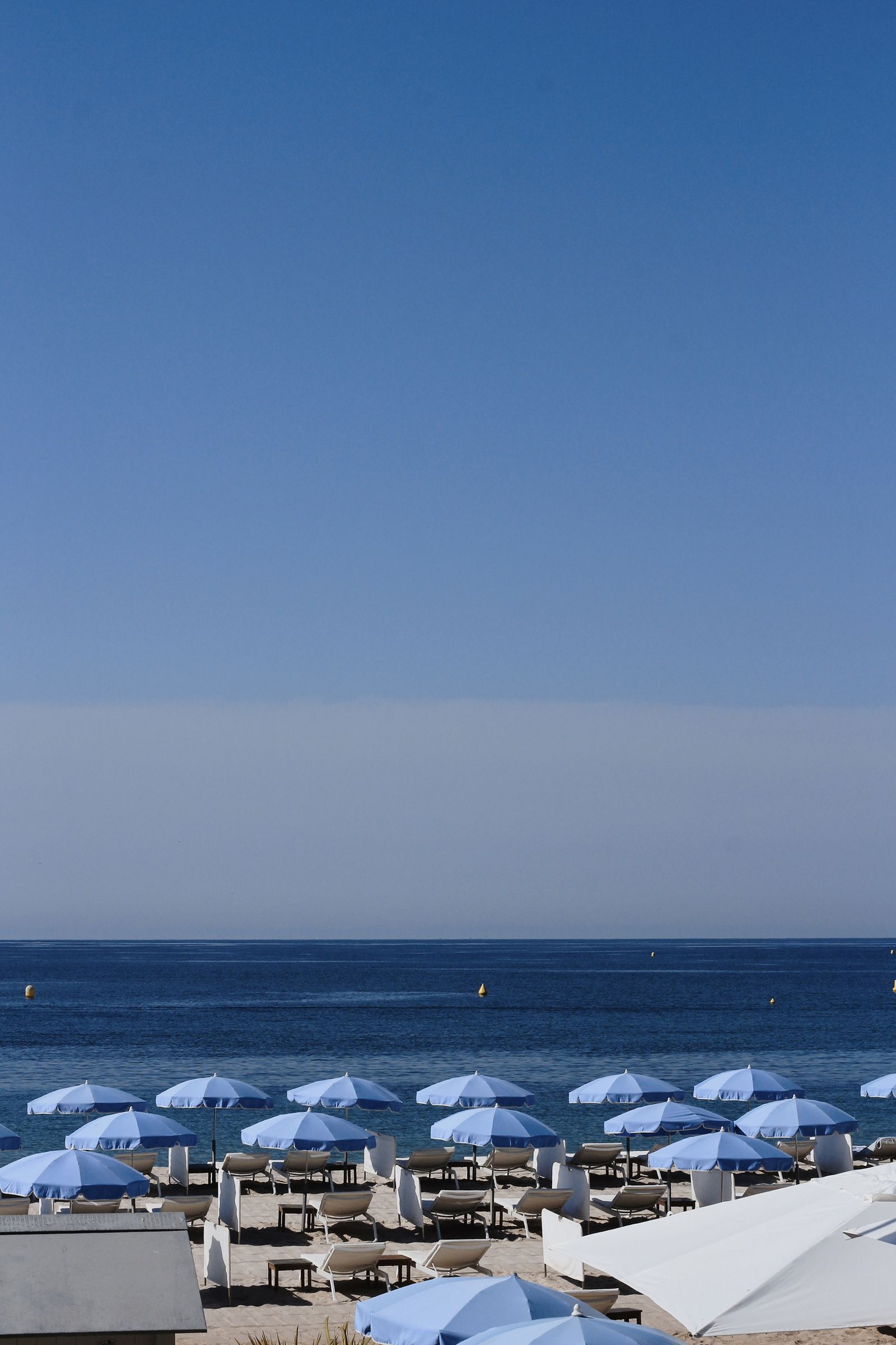 The sun setting over the Mediterranean horizon with calm blue waters.
