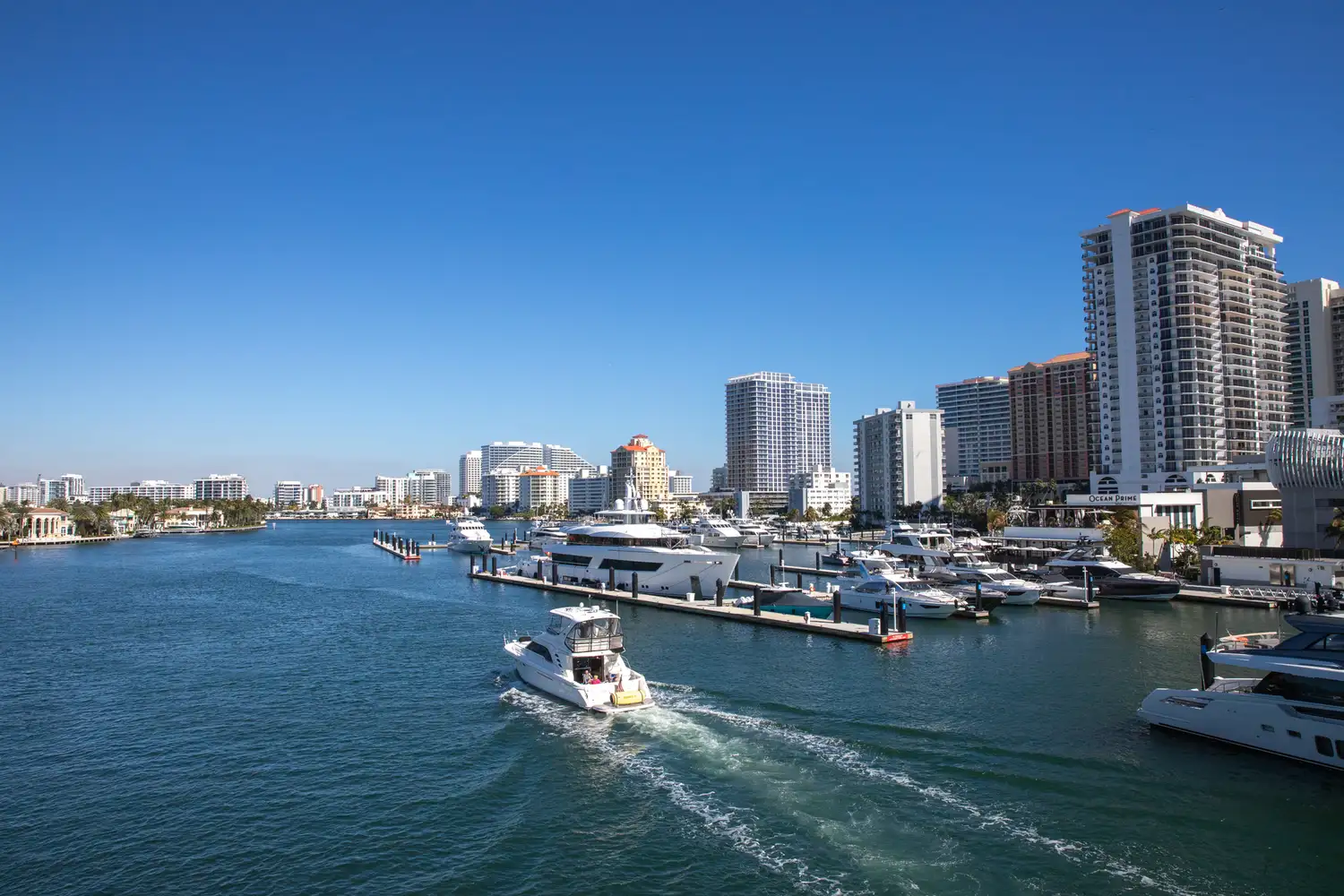 Boats cruising past the Fort Lauderdale coastal skyline.