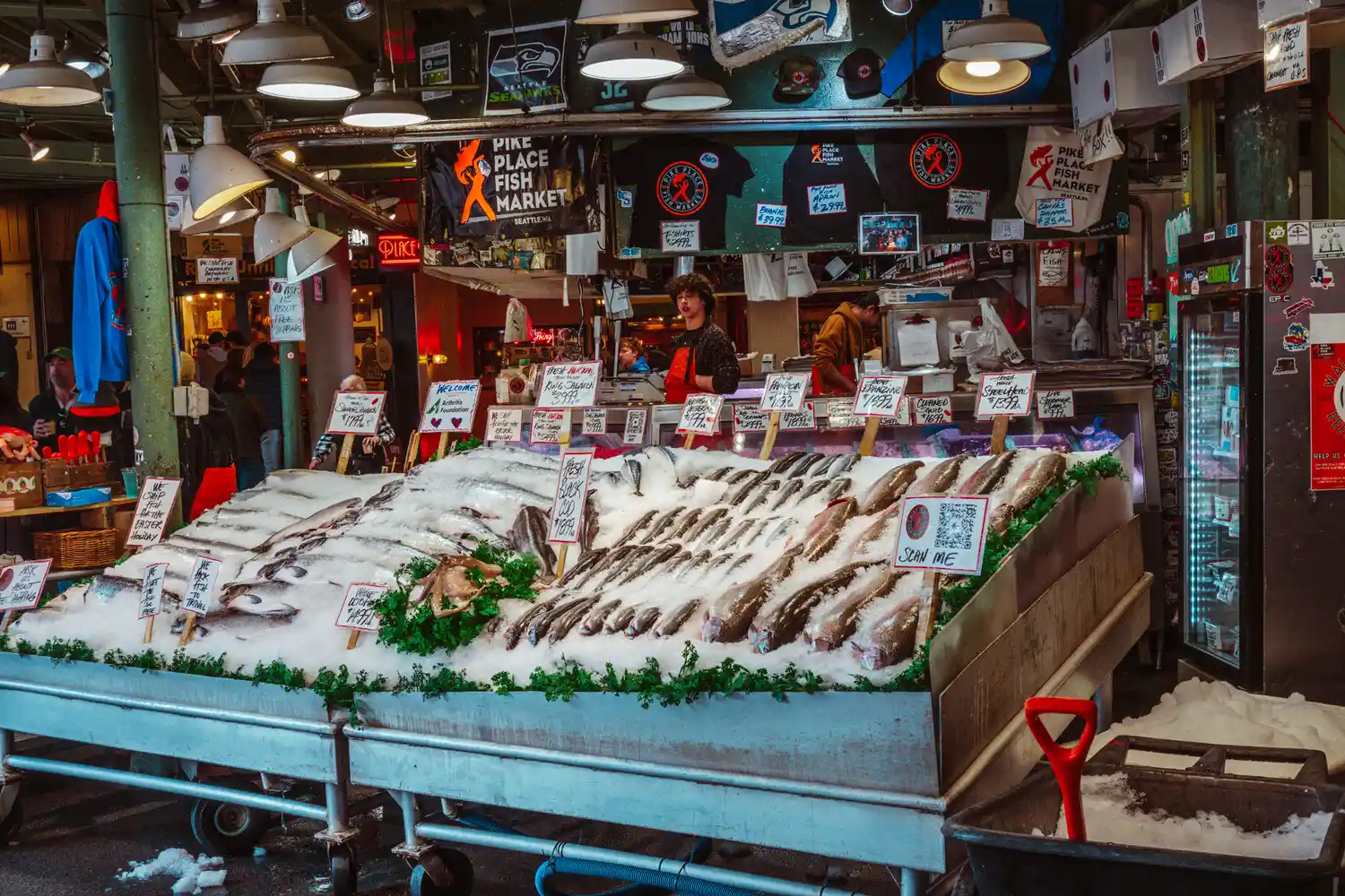 Fresh seafood market stall at Pike Place Market with fish on ice.
